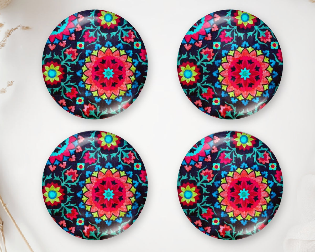 Four round handmade glass cabochons with intricate pink, turquoise and blue mandala designs