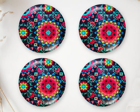 Four round handmade glass cabochons with intricate pink, turquoise and blue mandala designs