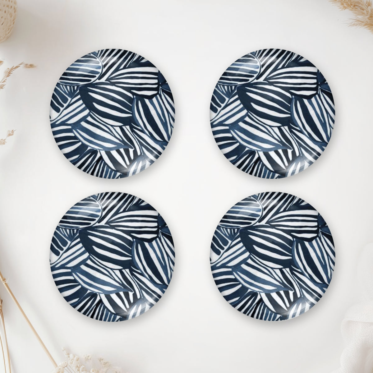 Four round photo cabochons with a navy blue and white leaf pattern