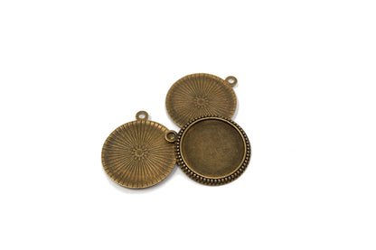 Close-up of round bronze cabochon settings showing the 25mm recessed tray.